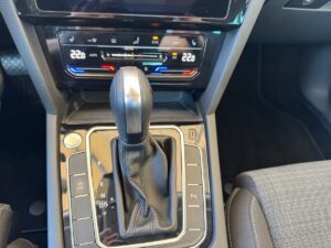 Automatikgetriebe in einem Auto mit digitaler Klimasteuerung und schwarz-silbernem Schaltknauf.