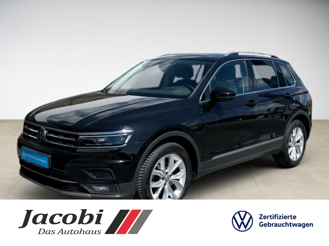 Schwarzer Volkswagen-SUV seitlich, glänzend, stehend, helle Felgen; Autohändler-Logo unten.