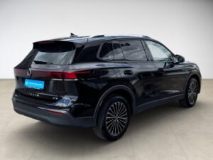 Schwarzer Volkswagen Tiguan in Seitenansicht, glänzend, elegantes Design, auffällige Felgen.