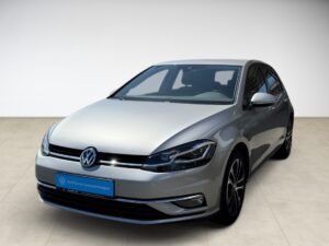Silberner VW Golf mit schwarzem Dach, moderner Stil, Scheinwerferdesign hervorgehoben.