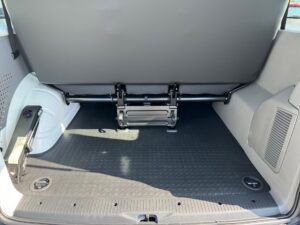 Kofferraum eines Fahrzeugs; leere, saubere Ladefläche mit gefalteter Rückbank und grauem Innenraum.