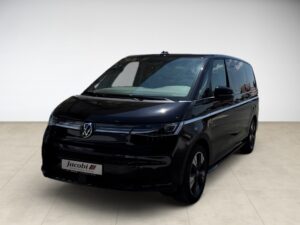 Schwarzer VW Van mit moderner Form, silberne Details, helle Umgebung, keine Personen sichtbar.