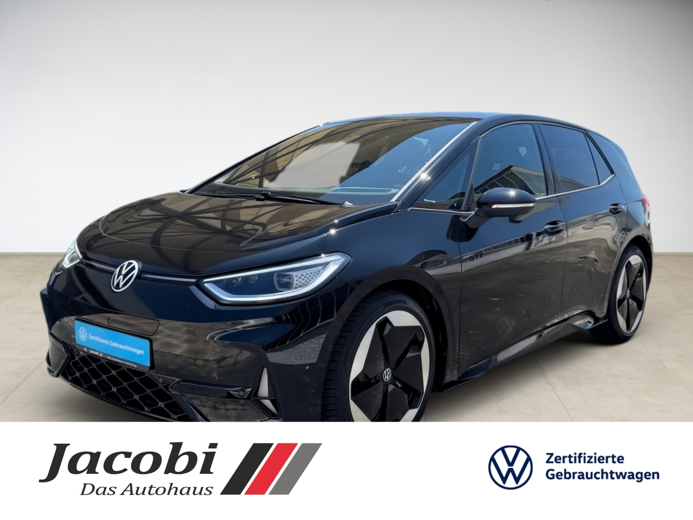 Schwarzer Volkswagen ID.3 PKW mit polierten Felgen. Im Hintergrund sind Logos sichtbarer Autohändler.
