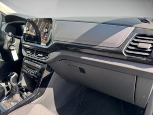 Innenraum eines Autos in moderner Optik mit schwarzem Armaturenbrett und integriertem Display.