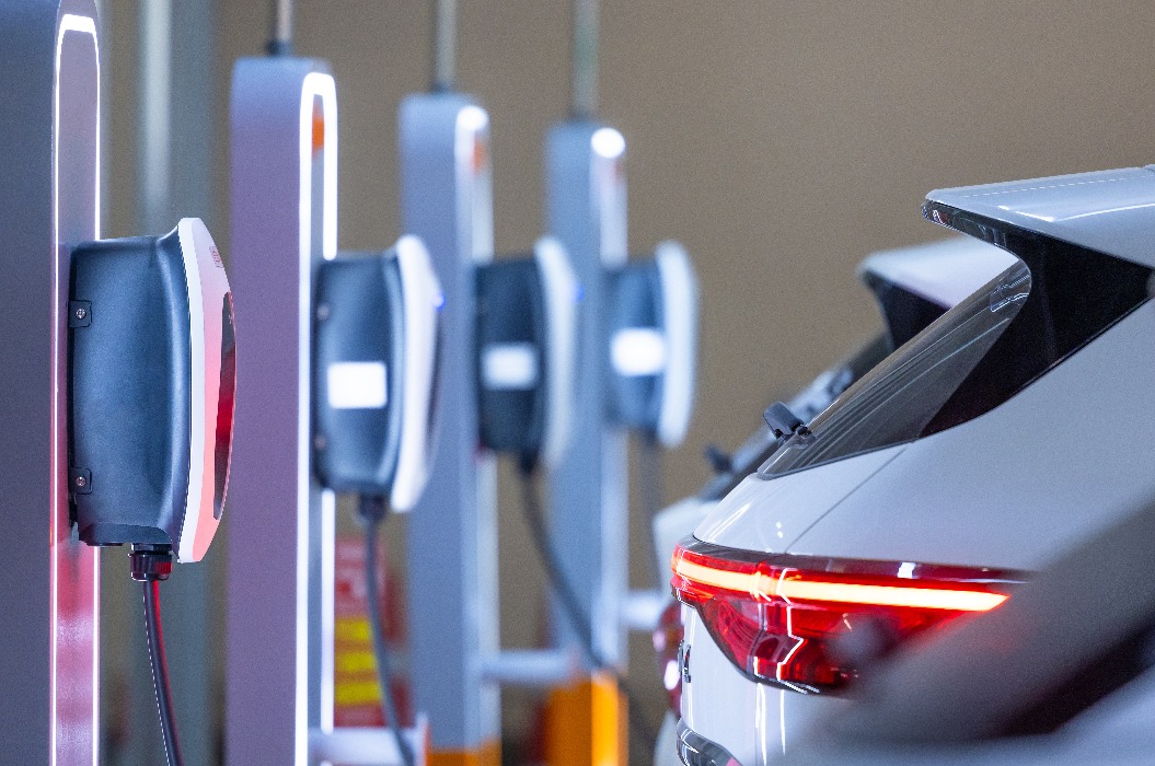 Ladestation für Elektrofahrzeuge und Elektroauto, Ladestation zum Aufladen von Elektrofahrzeug-Batterien, Stecker für Fahrzeuge mit Elektromotor, Ladestation für Elektrofahrzeuge mit sauberer Energie, Ladepunkt auf dem Parkplatz eines Kaufhauses.